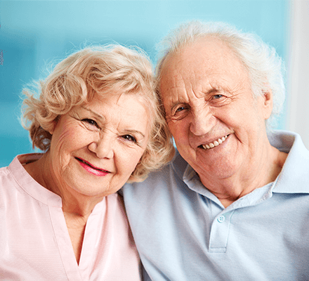Lakeview Tower familiar image of a happy elderly couple smiling, the man and women sitting down in each other's arms.