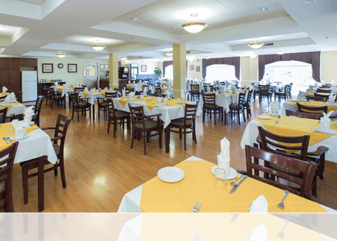 An inside view of the Garden Terrace Dining Room with tables nicely set and decorated.